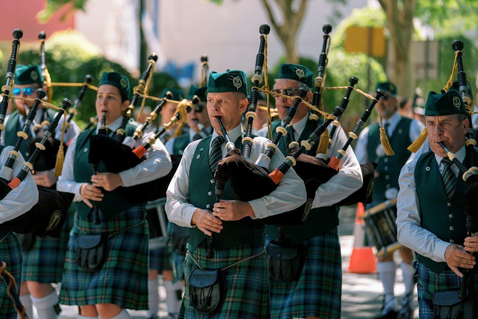 Bagpipers in kilts marching in a parade